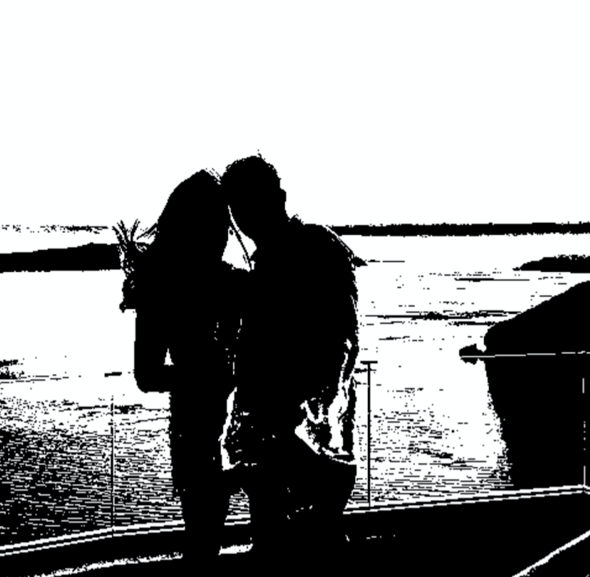 couple standing near water.